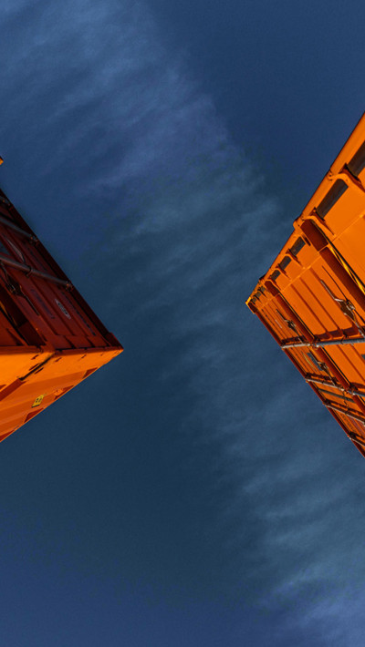 two large orange shipping containers 