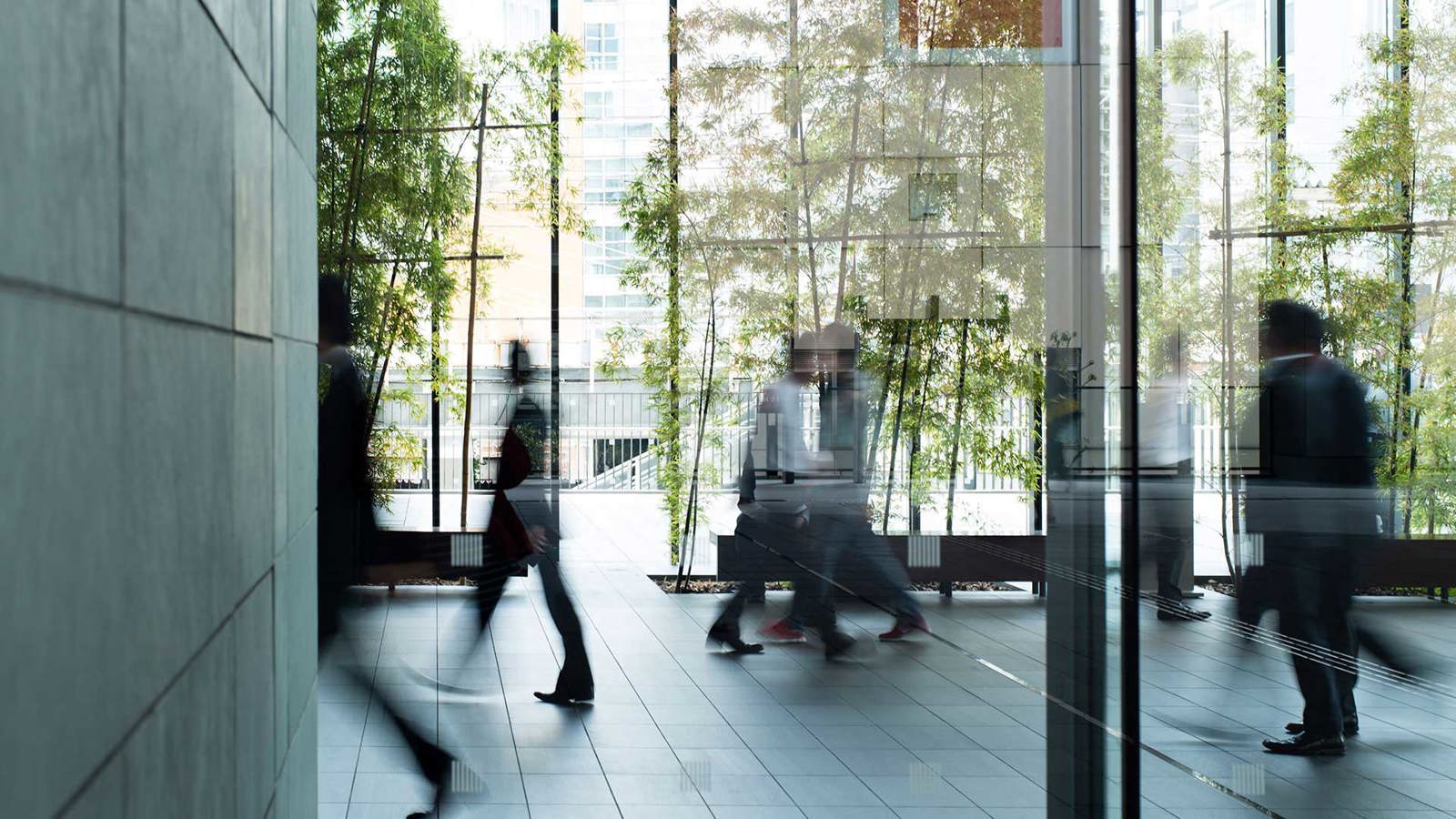 people walking through office