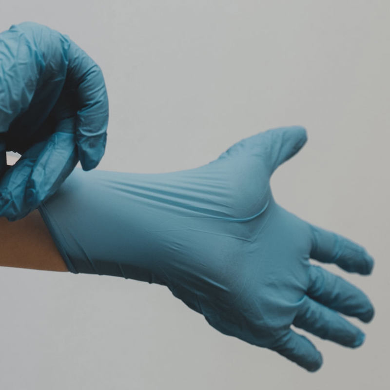 medical gloves being put on