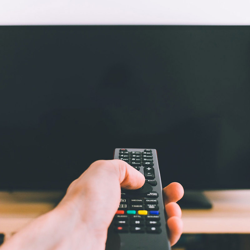 man holding tv remote control 